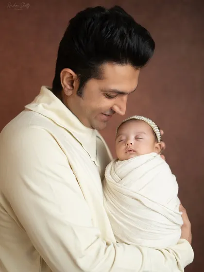 A father's gentle and loving gaze as he holds his sleeping newborn. These are the quiet moments that speak volumes.