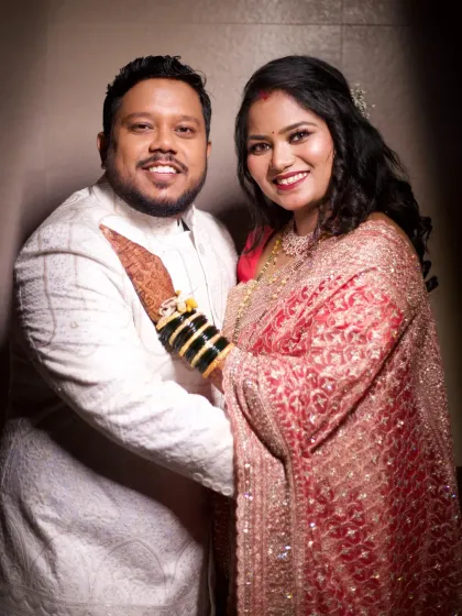 A beautiful reception portrait. The bride's makeup is radiant and polished, a perfect complement to her embellished pink saree.