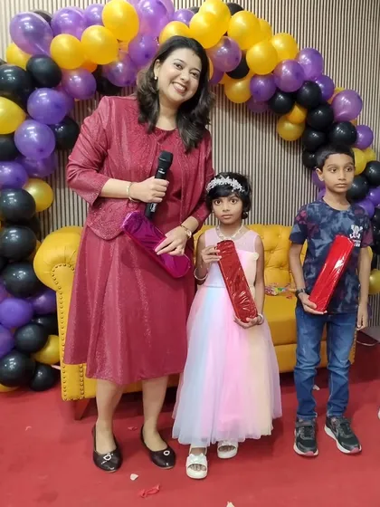 Posing with the young prize winners at a baby shower. I always make sure the kids are included in the fun with games and activities designed just for them.