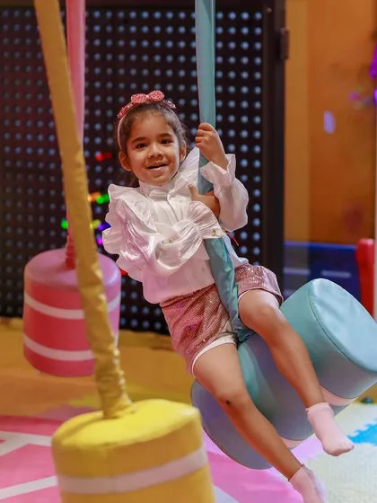A happy girl enjoying a ride on one of our unique swings, designed for safe and imaginative play.