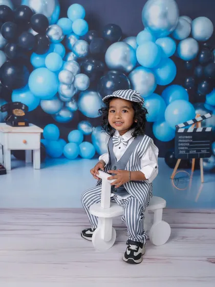 A big smile from the birthday boy on his tricycle. These action shots are perfect for capturing the energy of a toddler.