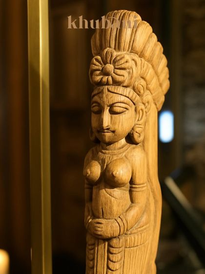 Our decor is filled with details that tell a story. This hand-carved wooden sculpture, with its serene expression, adds to the old-world palace feel of our majestic space.