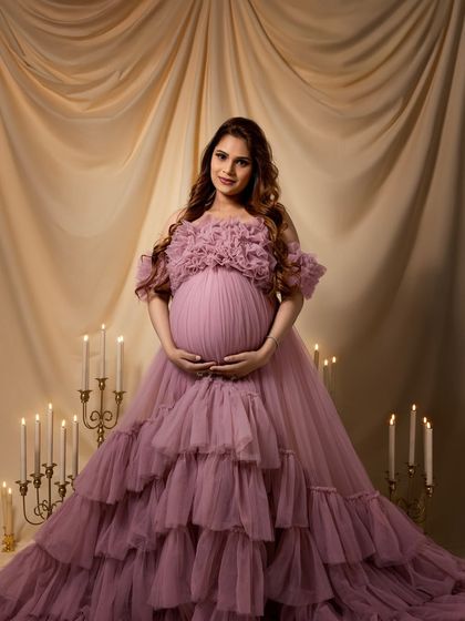 A full-frontal view, showcasing the stunning design of the gown and the beauty of the baby bump.