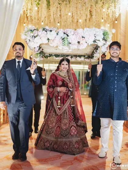 The bride's grand entrance under the phoolon ki chadar. I capture this traditional and emotional walk down the aisle with a sense of grace and importance.