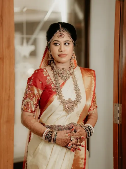 A classic bridal portrait. The bride's pose and expression exude grace and elegance, capturing a moment of quiet contemplation before the ceremony.