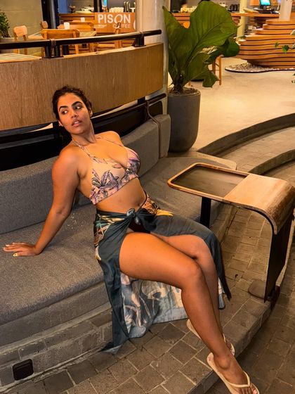 Lounging on a couch in my bikini and sarong. This look is perfect for going from the pool to a casual resort cafe.