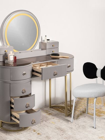 A new addition to our collection, this grey dressing table and vanity set features a round LED mirror and a cute bow-tie chair. The drawers are open to showcase the extensive storage capacity.