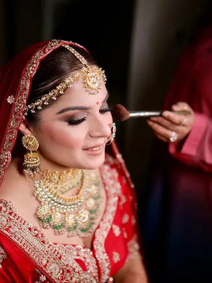 A candid smile during the makeup process. Creating a comfortable and happy environment is key. This bride's relaxed expression shows the trust she has in my work as I complete her traditional wedding day look.