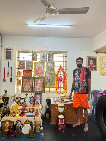 This is my gym, my temple. Here, our trophies and medals stand beside the gods I pray to. This is a place of discipline, faith, and the relentless pursuit of victory.