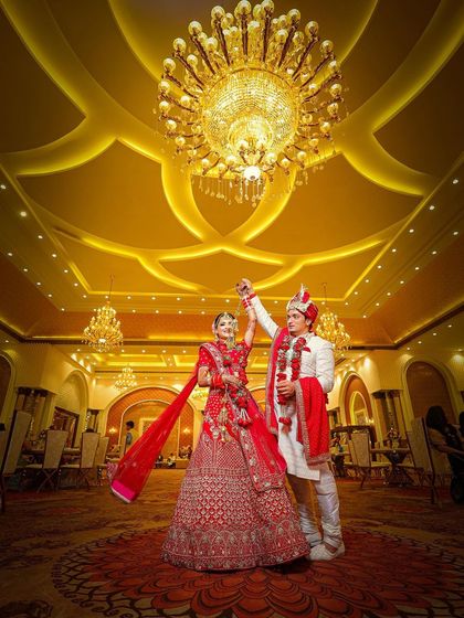 Capturing the movement of the bride's lehenga as the couple dances adds a dynamic and lively feel to the photo.