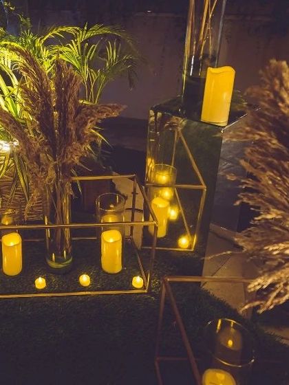 We love mixing textures for a modern rustic look. Here, dried pampas grass is paired with geometric glass boxes and an abundance of warm LED candles to create a chic and inviting decor corner.