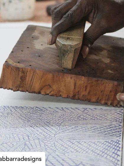 Our collaboration with the artisans of Bábbarra Designs is a story that continues to unfold. Here, they are selecting historic lino tiles which our artisans will translate into durable teak woodblocks, preserving their craft for a new generation.