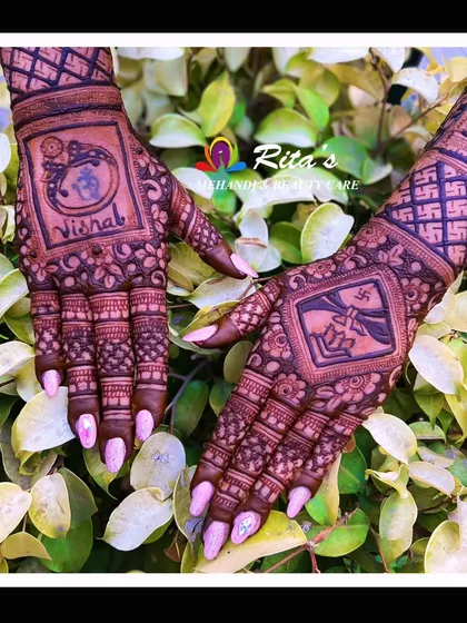 The back of the hands for a wedding, featuring unique elements. One hand has the groom's name with a Krishna motif, while the other has a Swastik and lotus design.