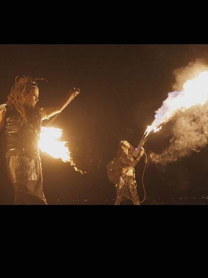 A dramatic shot of our duo show, with one performer using a flamethrower while the other spins fire. This highlights the scale and impact of our group acts.
