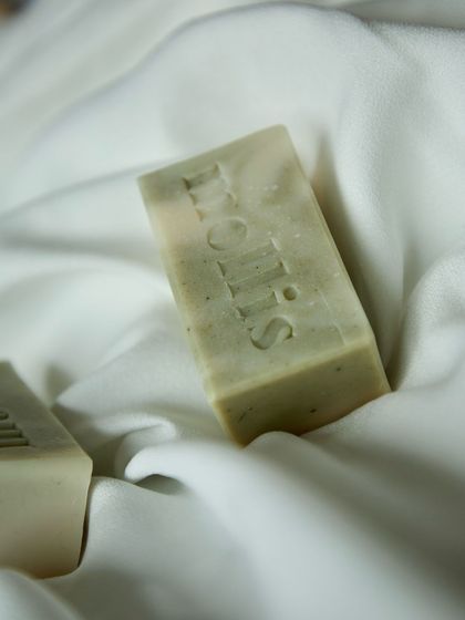 The 'Minty Breeze' bar on a soft, white cloth, highlighting its natural green color.