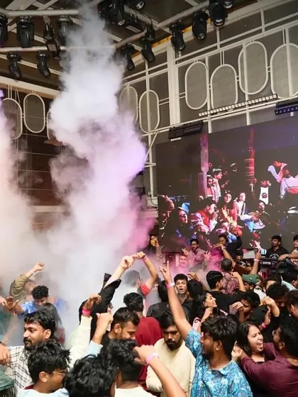 Another epic shot of the smoke cannons filling the room, creating a festival-like atmosphere.