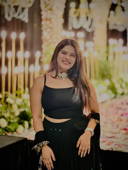 Posing by the stunning candle-lit decor at a wedding reception. The ambiance was pure magic.