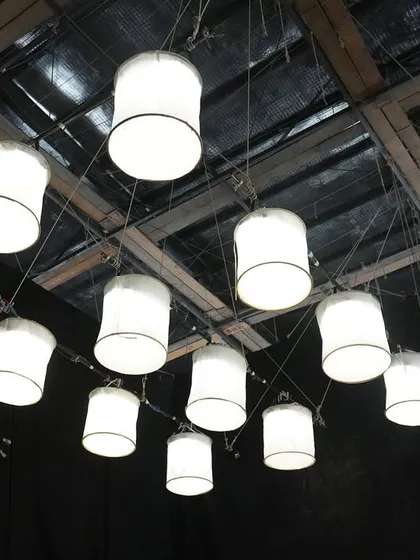 A close-up of the hanging lanterns created with Prolights ECL panels. This showcases a creative use of professional lighting fixtures to serve as set decoration.