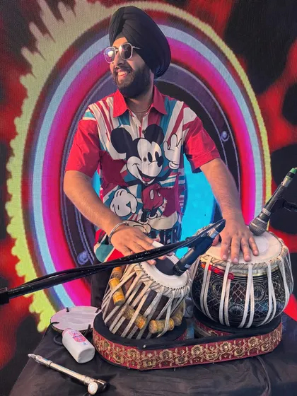 A cool shot of me on stage with my tabla, ready to perform. The Mickey Mouse shirt shows my fun side.
