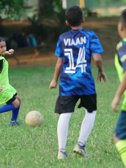 Football is for everyone. We are proud to coach determined and skillful players, both boys and girls, helping them develop their passion for the game. Here, one of our young female players showcases her control and awareness during a practice match.