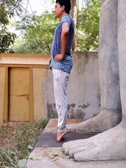 Continuing the foot strengthening sequence, this image shows a balance on the balls of the feet. This simple yet powerful exercise improves ankle stability and can be therapeutic for those with flat feet.