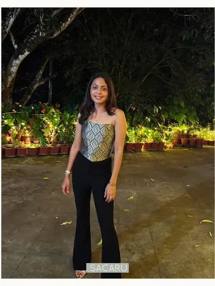 Our client Bhavani dressed up in a custom, signature Sacaru gold and silver brocade corset top, paired with classic black flared trousers.