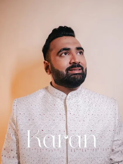 A thoughtful portrait of the groom, Karan, looking elegant in his reception sherwani.