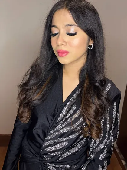 The eye makeup details are key for this glam look, with a bright silver shimmer on the lid.