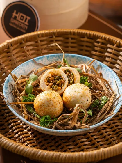 A creative presentation of stuffed rice balls in a nest. This kind of unique plating is great for catching a customer's eye.