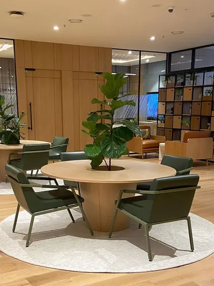Our furniture transforming a workspace into a productive and stylish environment. This project features our custom round tables and comfortable, durable armchairs in deep green leather, designed for a high-end office lounge.