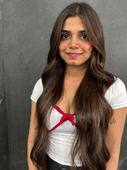 A girl who colors her hair is creative beyond measure. This client is rocking her long, subtly highlighted hair.