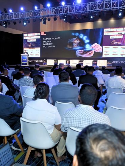 A full conference hall listens to a keynote on the Indian smart home market potential, a key topic for exhibitors and investors.