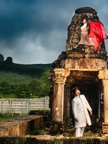 Another shot from the Anjaneri, Nasik series, this time with the groom looking up at his bride. The dramatic clouds and lush green hills add a moody, romantic feel to this epic location shoot.