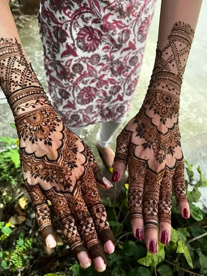 A full view of a siders mehendi, with beautiful patterns on both hands.