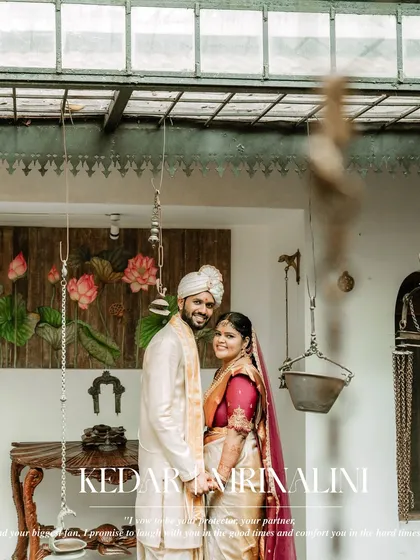 A happy portrait of the couple in their traditional wedding attire, captured in a rustic, artistic setting.