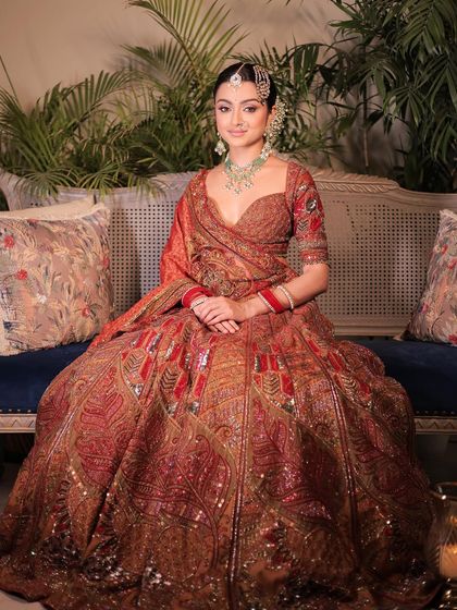 A portrait of modern royalty. This bride's complete look, from the rich, detailed lehenga to the soft, glowing makeup, creates an image of pure elegance and poise.