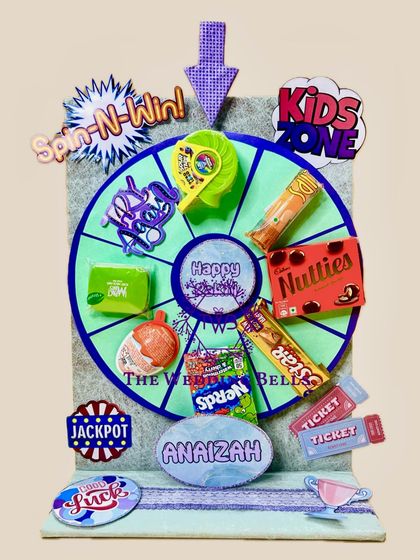 Another look at our personalized "Spin-N-Win" Rakhi hamper, this time for Anaizah. We can customize the colors and treats to match any child's favorites.