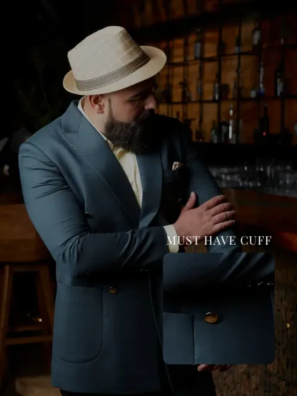 A close-up on the cuff and pocket detail of the deep teal suit, showcasing the must-have features and meticulous tailoring that define my work.