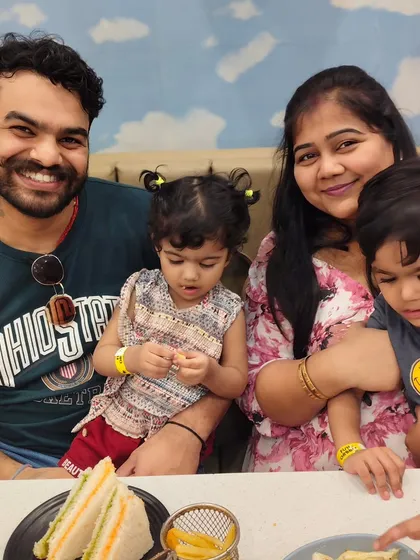 We believe in fun for the whole family. While the kids are busy exploring, parents can relax and enjoy a meal together in our comfortable café. Here's a happy family enjoying our tasty sandwiches and fries.
