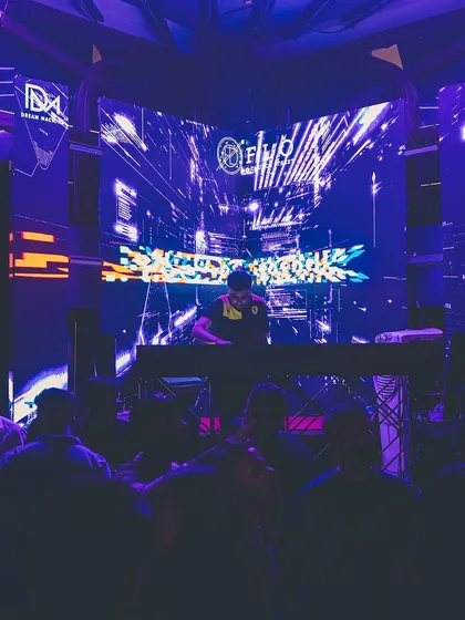 A wide shot of me at the console at Flo, with a complex visual display on the screen behind me.