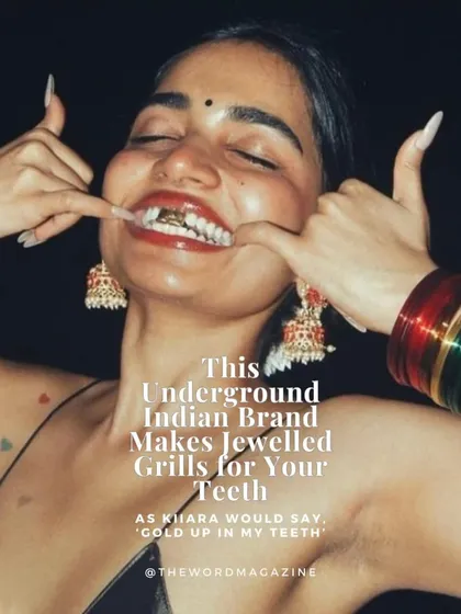 A close-up shot of a custom gold grill set, featured in The Word Magazine. This piece captures the vibe of Frostbite perfectly: bold, expressive, and rooted in a modern Indian aesthetic, complete with traditional jhumka earrings and a bindi.