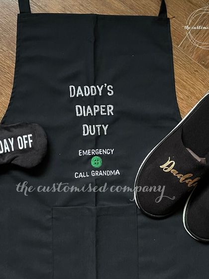 Don't forget the new dad! This "Daddy's Diaper Duty" gift set includes a humorous apron, personalized "Daddy" slippers, and a "Daddy's Day Off" eye mask to make him feel special and appreciated.