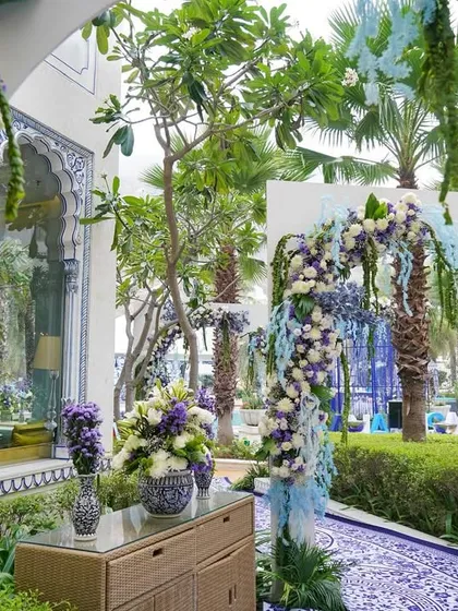 The entrance to the celebration, with arches adorned in cascading blue and white florals, leading guests into the beautifully themed space.