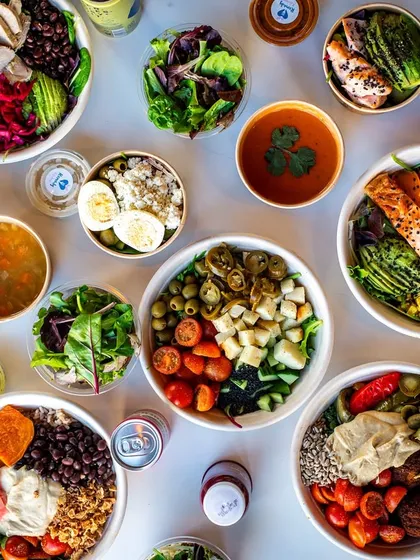 A full spread of healthy bowls and soups, shot from above. This "flat lay" style is great for showing the variety of a menu.