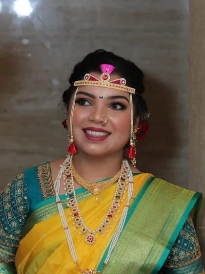 A candid shot capturing the bride's happy expression. The makeup is designed to look fresh and vibrant.