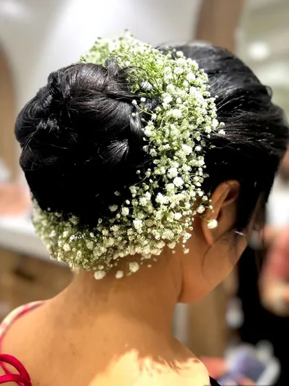 Another angle of the beautiful floral bridal bun. This style keeps the hair neatly off the face while looking incredibly graceful.