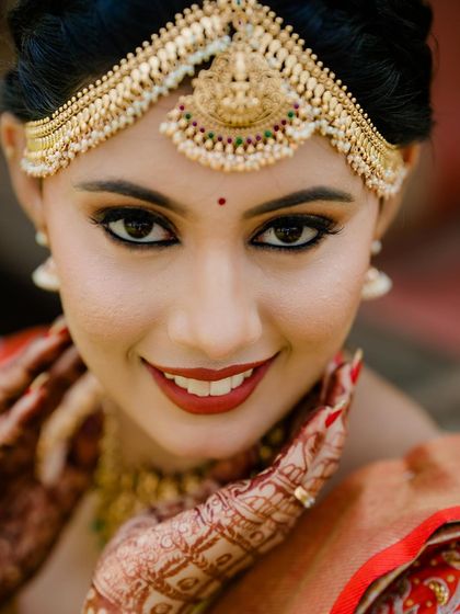 A stunning close-up of our bride Annanya. This shot highlights the beautiful craftsmanship of the traditional gold matha patti, a key element of the South Indian bridal look.