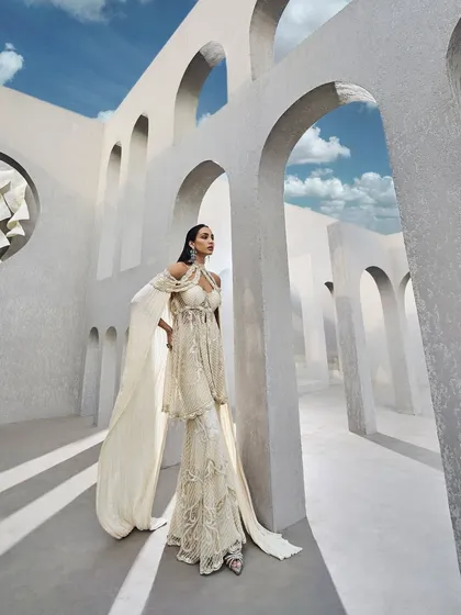 The ivory sharara set, a look that shines from every angle, just like a prism. A perfect choice for the modern bride.