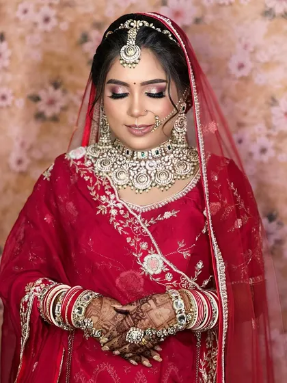 Another view of the red bridal look, focusing on the stunning contrast between the red outfit and the white Kundan jewellery.