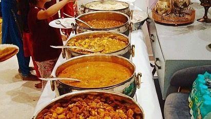 Guests enjoying the delicious vegetarian spread at a post-hawan lunch. My menu for such occasions is both traditional and flavorful.